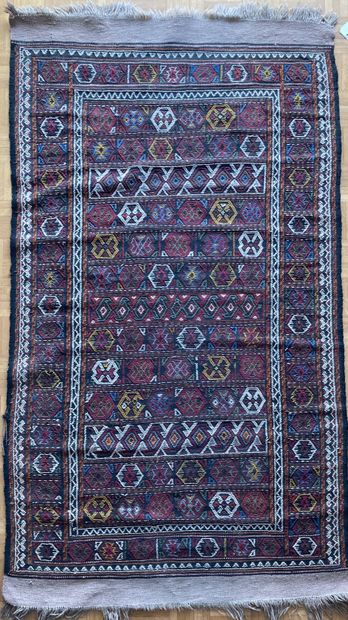 Woven and embroidered carpet decorated with...