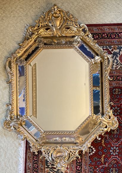 Mirror with a gilded wood frame, the angles...