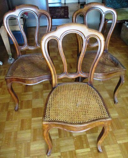 A suite of three natural wood chairs, the...
