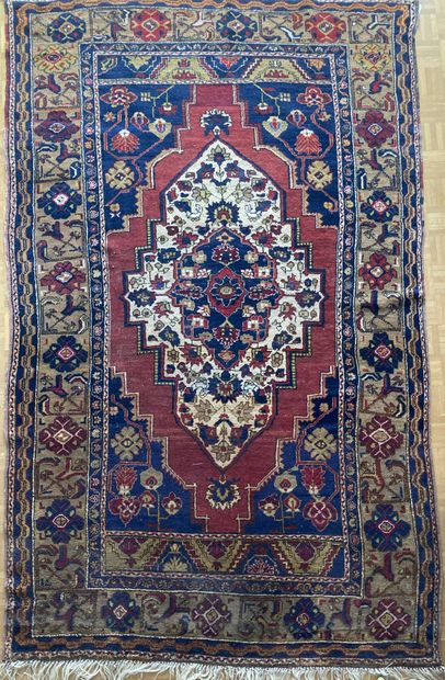 Oriental wool carpet decorated with a central...