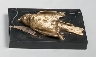 A gilt bronze paperweight with a dead bird....