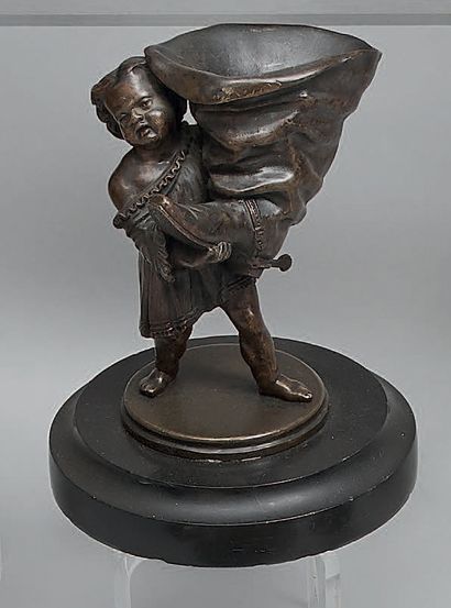 A patinated bronze match holder, showing...