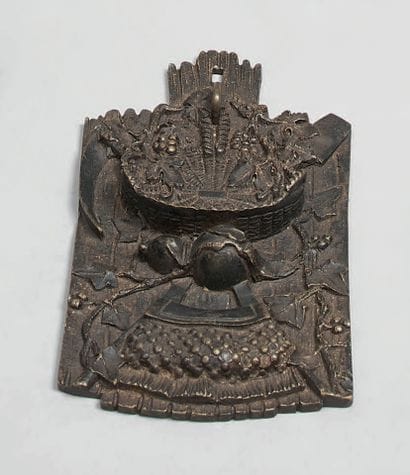 A patinated bronze watch-holder, chiselled...