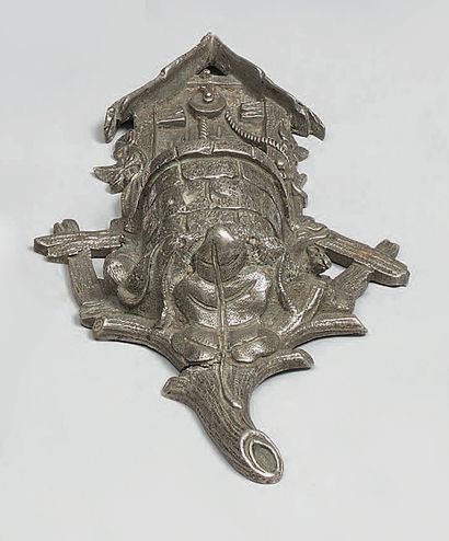 Bronze watch holder with silver patina, showing...
