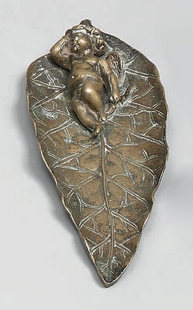 A patinated bronze tray, showing Amour endormi...