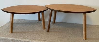 
Two coffee tables in natural wood, the almond-shaped...