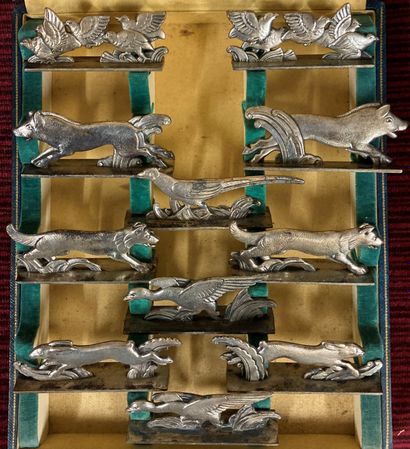 Suite of eleven silver plated knife holders...