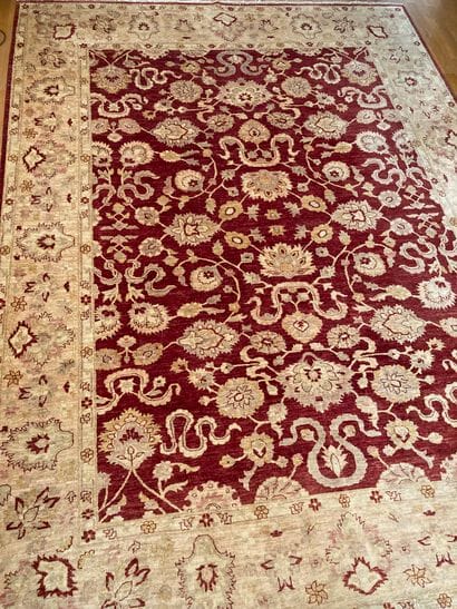 Oriental carpet in wool with red background,...