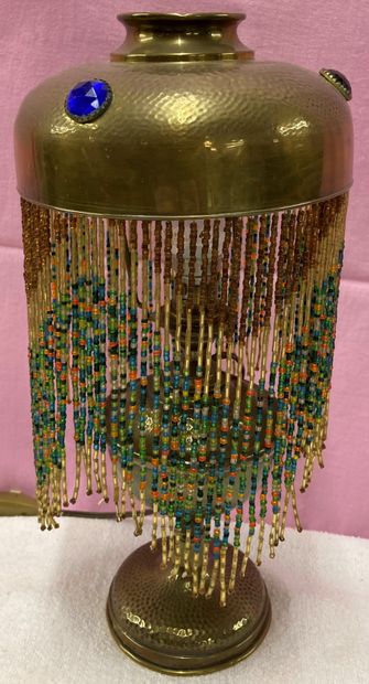 Old oil lamp in hammered brass, the lampshade...