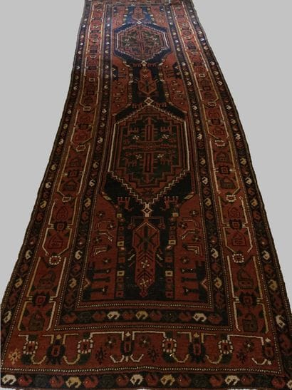 Oriental wool carpet decorated with two rhombuses...