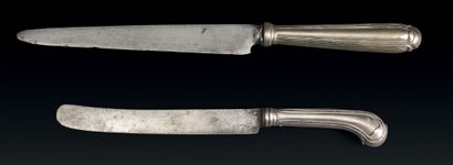 Two knives, the handles in silver, the blades...