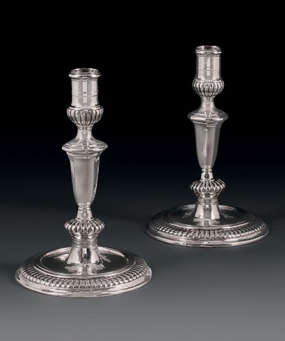 Pair of silver torches, standing on a round...