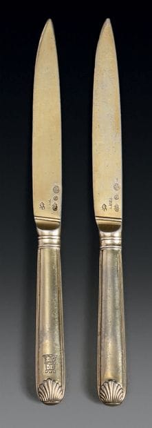 Two knives in gilt, model with nets and shells,...
