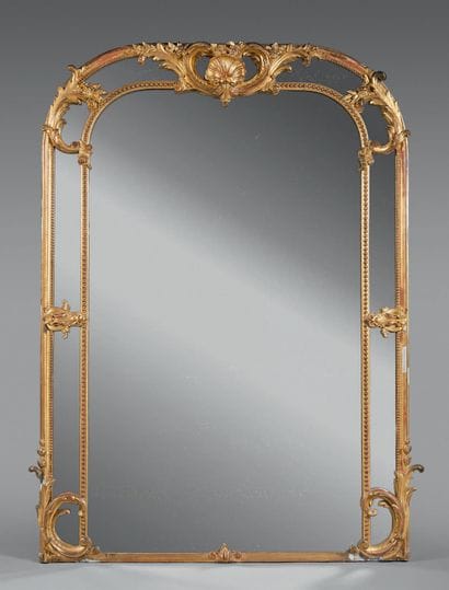 Mirror with gilded wood frame, the upper...