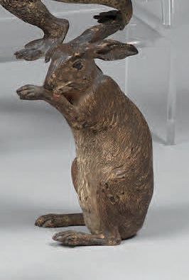 Seated hare licking a paw. H. : 9 cm. L....