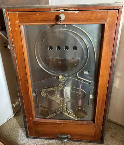 Antique slot machine in varnished wood edged...