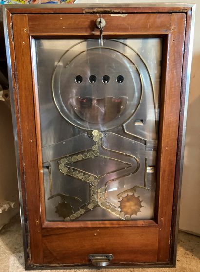 Antique slot machine in varnished wood edged...