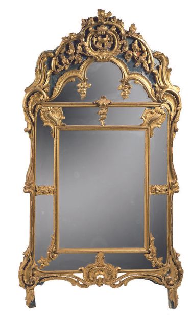 Large mirror with gilded wood frame. Decorated...