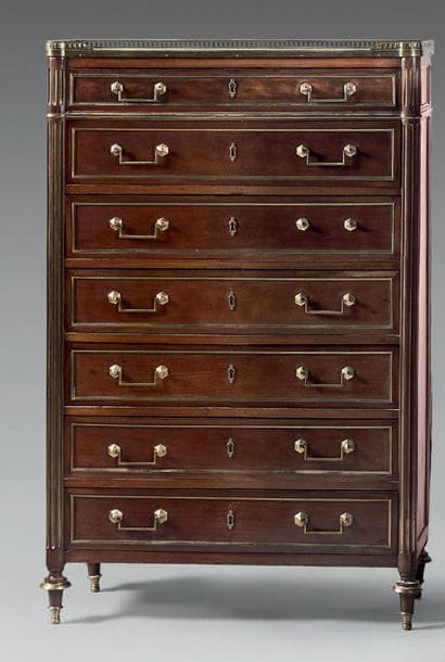 Mahogany and mahogany veneer semainier. Ornamented...