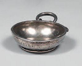 A plain silver wine cup, standing on a rush,...