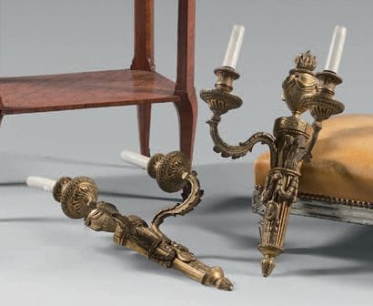 Pair of gilt bronze sconces. The shaft surmounted...