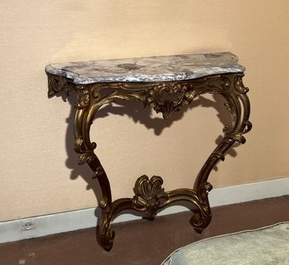Wall console in gilded wood decorated with...