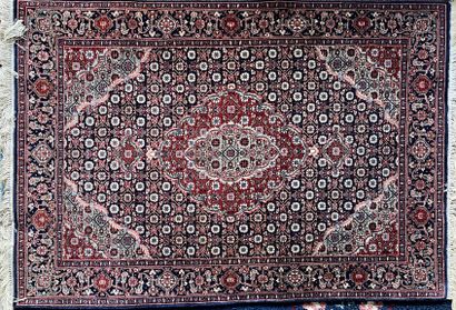 Oriental wool carpet decorated with gray-blue...