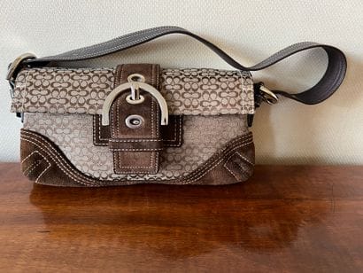 COACH. Clutch in monogrammed canvas and chocolate...