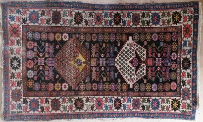 Oriental wool carpet decorated with two pentagons...