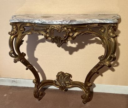 Wall console in gilded wood decorated with...