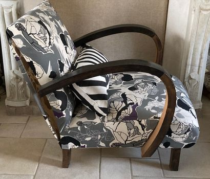 Two armchairs in natural wood, one of them...