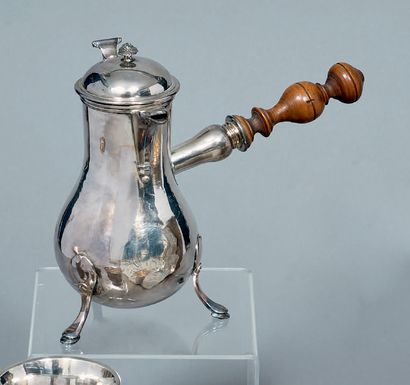 A baluster-shaped silver pourer, standing...