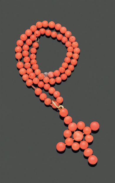 Coral beads necklace holding a cross pendant...