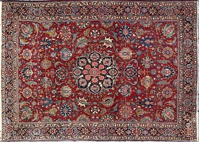 Oriental wool carpet decorated with a central...