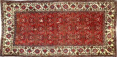 Oriental wool carpet decorated with floral...