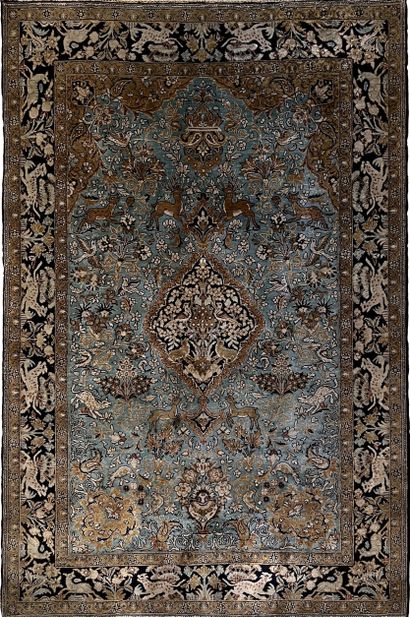 Persian carpet in wool and silk decorated...