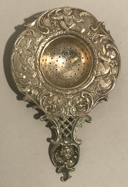 Silver tea-passer (800), chased of loves...