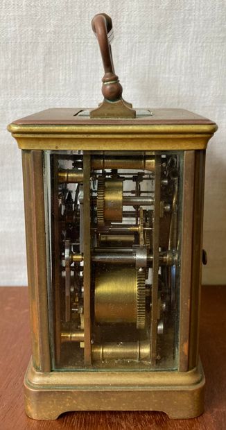 Travelling clock, the bronze cage mount surmounted...