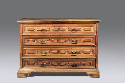 Chest of drawers in molded fruitwood. The...