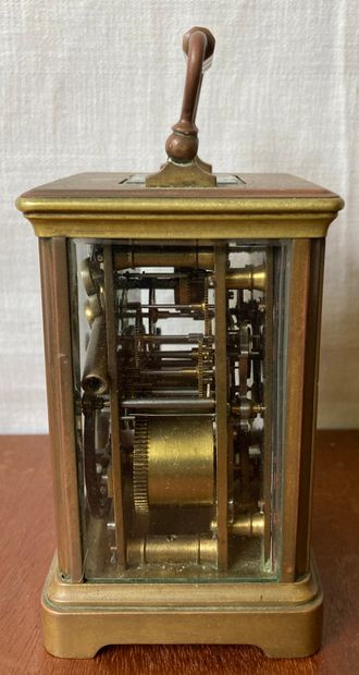 Travelling clock, the bronze cage mount surmounted...