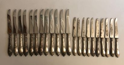 Twelve large knives and ten cheese knives,...