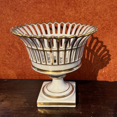 White and gold porcelain openwork cup on...