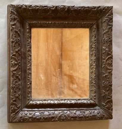 Carved oak frame decorated with cartouches...