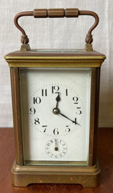 Travelling clock, the bronze cage mount surmounted...
