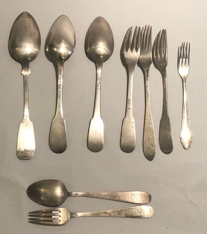 Three spoons and three forks mismatched in...