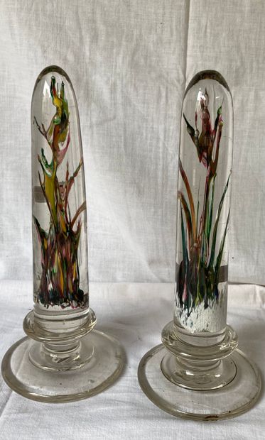 Pair of glass obelisks, the interior with...