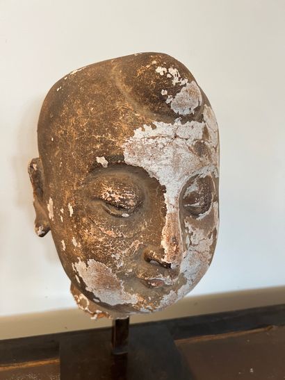 Head of Buddha in wood and stucco with golden...
