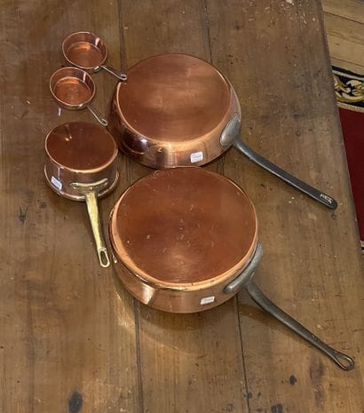 Pots, pans and kitchen utensils in red c...