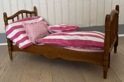 Doll's bed in natural wood, the bedsides...