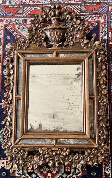Mirror with a gilded wood frame decorated...